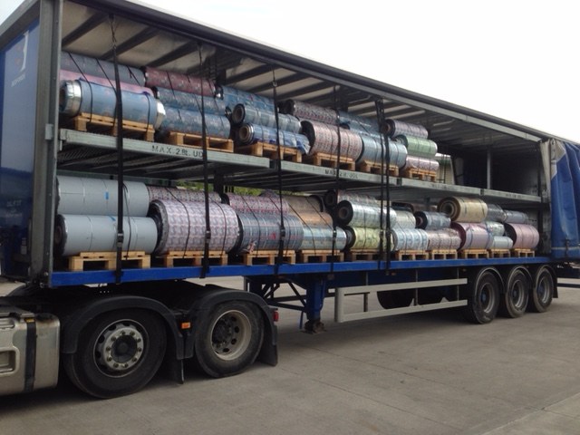 Reels loaded along a curtain-sided articulated trailer