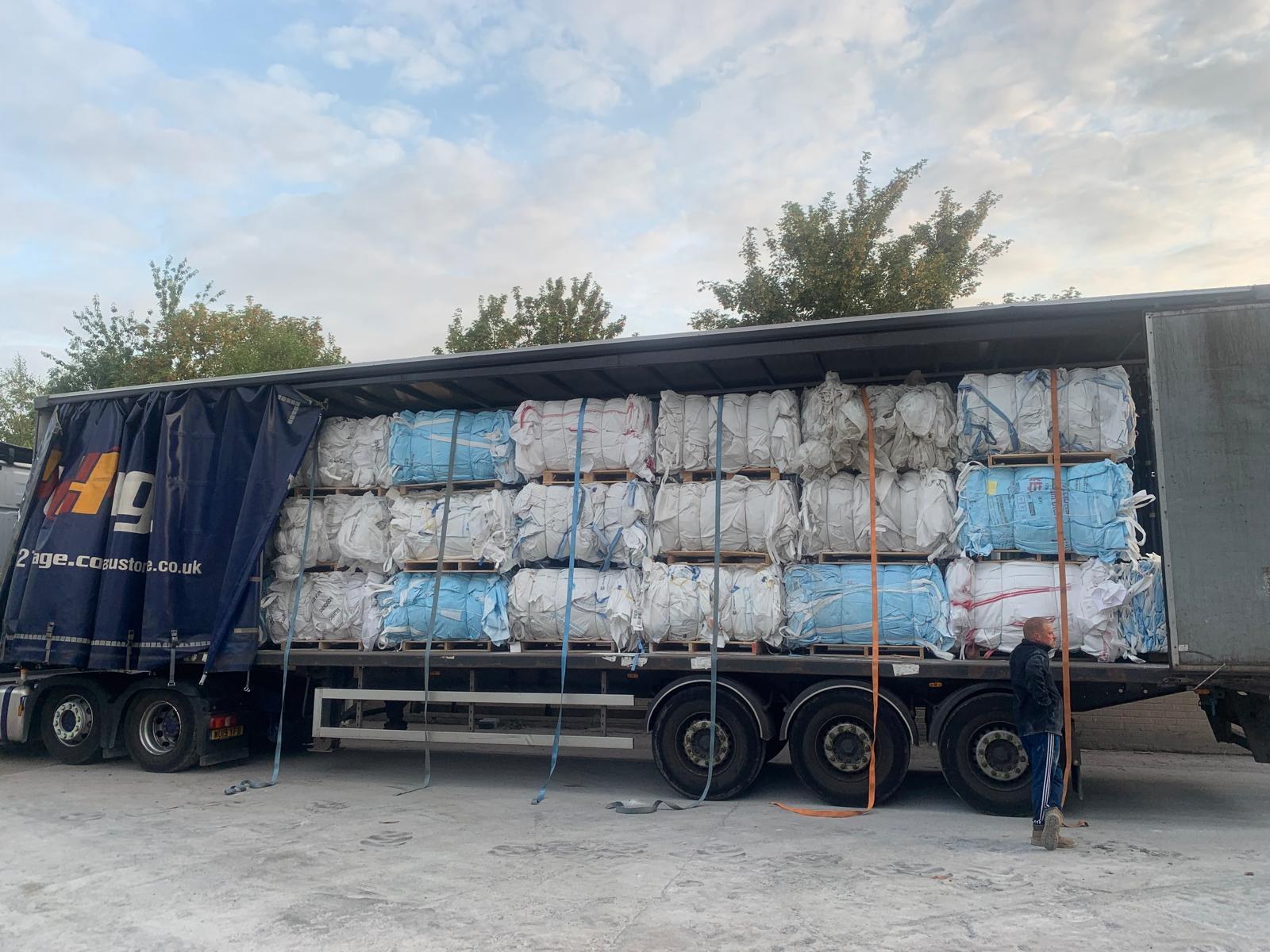 Poly-Cycle collection trailer carrying baled recyclable materials